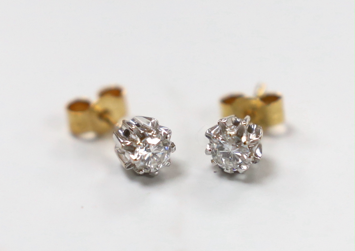 A pair of yellow metal and solitaire diamond set ear studs, gross weight 1.5 grams.